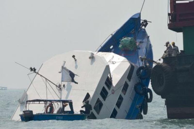 Hong Kong authorities board the partially submerged Lamma IV today to search for survivors and answers to why boats collided killing 36 last night.