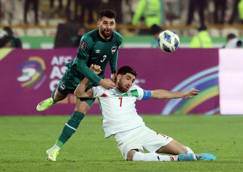 Iraq's Frans Dhia Haddad tackles Iran's Alireza Jahanbakhsh. Reuters