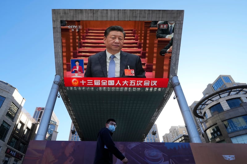 Chinese President Xi Jinping appears on a screen at a mall, during a live broadcast of the opening ceremony of the National People's Congress, on Saturday. AP