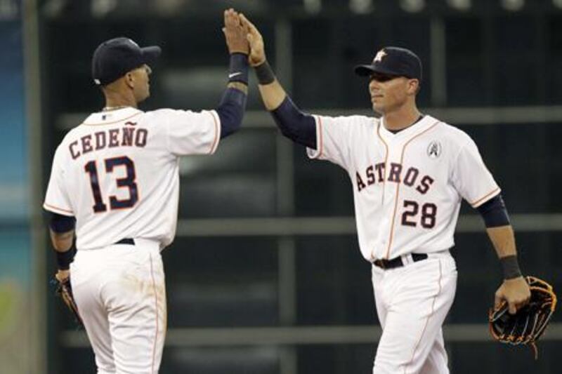 Houston's Ronny Cedeno high fives Rick Ankiel after the final out against the Texas Rangers.