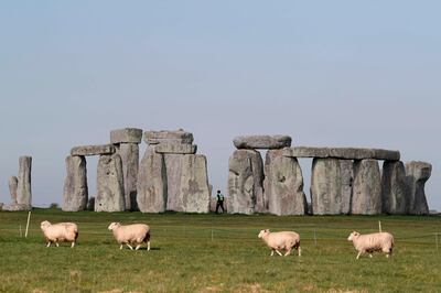(FILES) In this file photo sheep graze as security guards patrol the prehistoric monument at Stonehenge in southern England, on April 26, 2020, closed during the national lockdown due to the novel coronavirus COVID-19 pandemic.  Stonehenge, a Neolithic wonder in southern England, has vexed historians and archaeologists for centuries with its many mysteries: How was it built? What purpose did it serve? Where did its towering sandstone boulders come from?
The answer to the last question may finally have an answer after a study published July 29, 2020 found that most of the giant stones -- known as sarsens -- seem to share a common origin 25 kilometers (16 miles) away in West Woods, an area that teemed with prehistoric activity.
  / AFP / Adrian DENNIS
