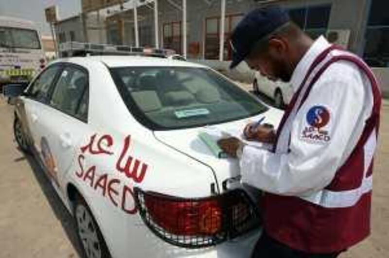 ABU DHABI.15th September 2008. PRIVATE TRAFFIC POLICE. Saaed patrol officer Ahmed Mubarak takes driver details at  the scene of car accident in Mussafah. Stephen Lock / The National. Story.Matt Chung *** Local Caption ***  SL-traffic-009.jpgOP18SE_Letters.jpg