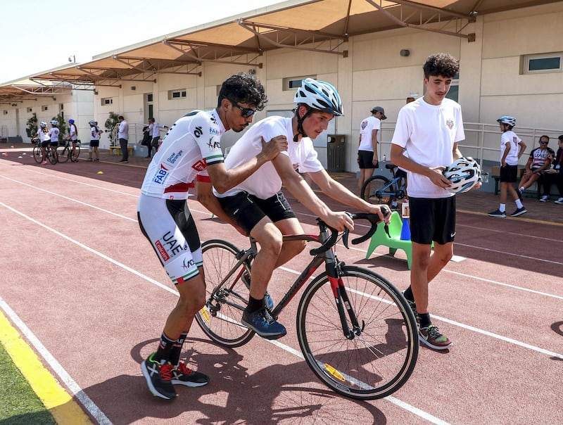 Abu Dhabi, U.A.E., October 29, 2018.  UAE Cycling Team Emirates visit the Al Yasmina School to give a brief cycling workshop.  Yousif mirza teaches Saif Al Ali how to ride a bike.
Victor Besa / The National
Section:  SP
Reporter:  Amith Passela