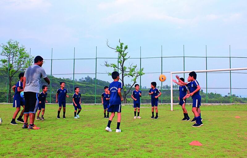 Children practise their footballing skills at the Sahara Football Academy in Pokhara, Nepal. The centre, which opened in 1998, trains and educates children from families that are unable to support them. Bibek Bhandari for The National