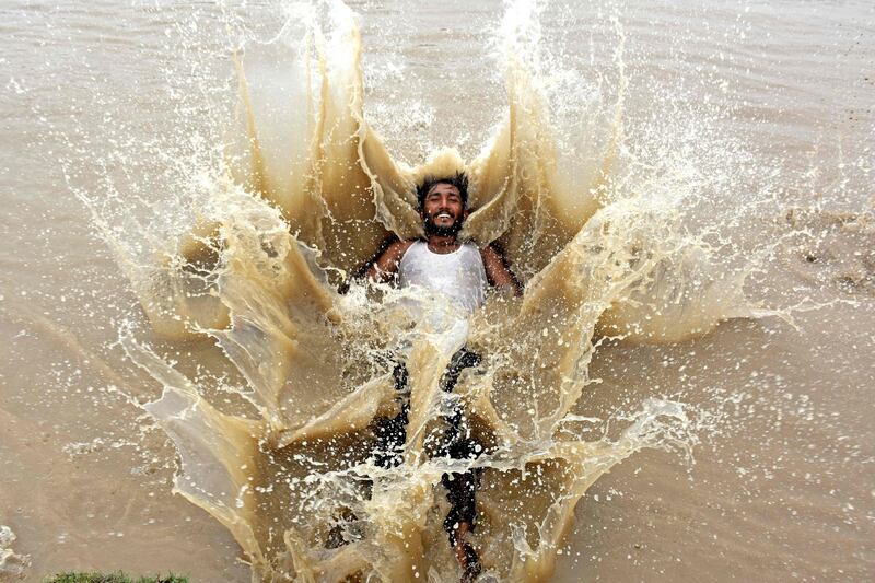 A man dives into a canal during a hot day in Larkana district of Sind province. AFP