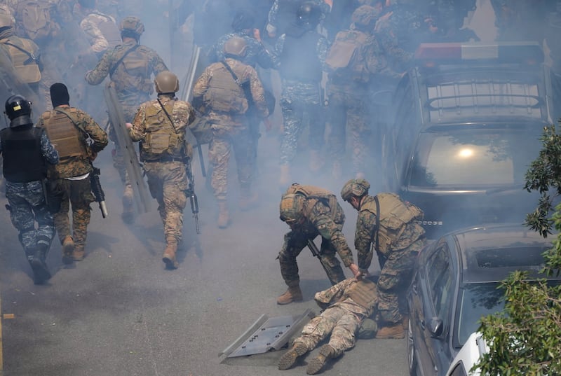 Lebanese special forces soldiers help a comrade suffering from the effects of tear gas in Beirut. AP Photo