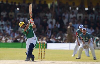 Pakistan XI batsman Yasir Hameed (L) hits a shot during a T20 cricket match between Pakistan XI and UK Media XI at the Younis Khan Cricket Stadium in Miranshah, the former stronghold of Al-Qaeda and Taliban militants, in North Waziristan near the Afghan border on September 21, 2017. / AFP PHOTO / AAMIR QURESHI