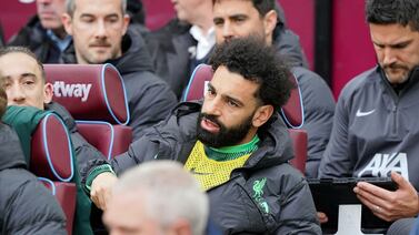 Liverpool's Mohamed Salah sits on the substitute bench ahead of the English Premier League match between West Ham United and Liverpool, at London stadium, in London, Saturday April 27, 2024.  (Jonathan Brady / PA via AP)