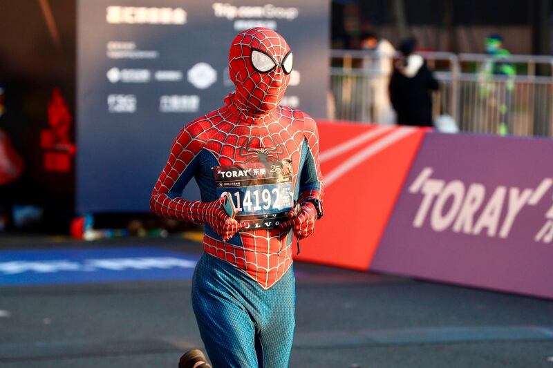 A runner wearing a spider man costume takes part in the 2020 Shanghai marathon. AFP