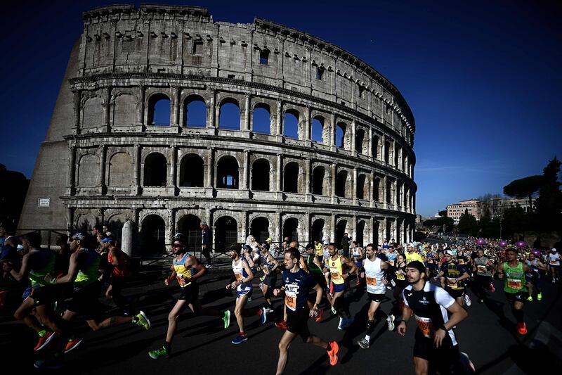 Competitors run past the Colosseum during the Rome Marathon. AFP