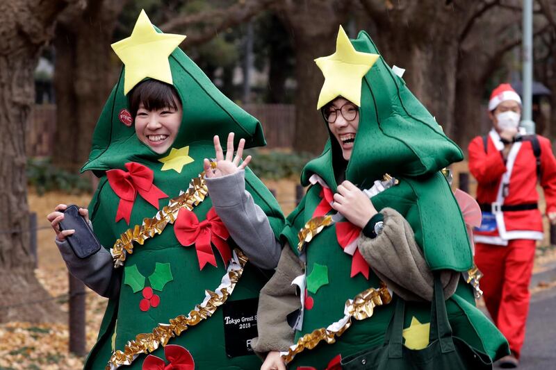 Participants dressed as Christmas trees prepare to run. EPA