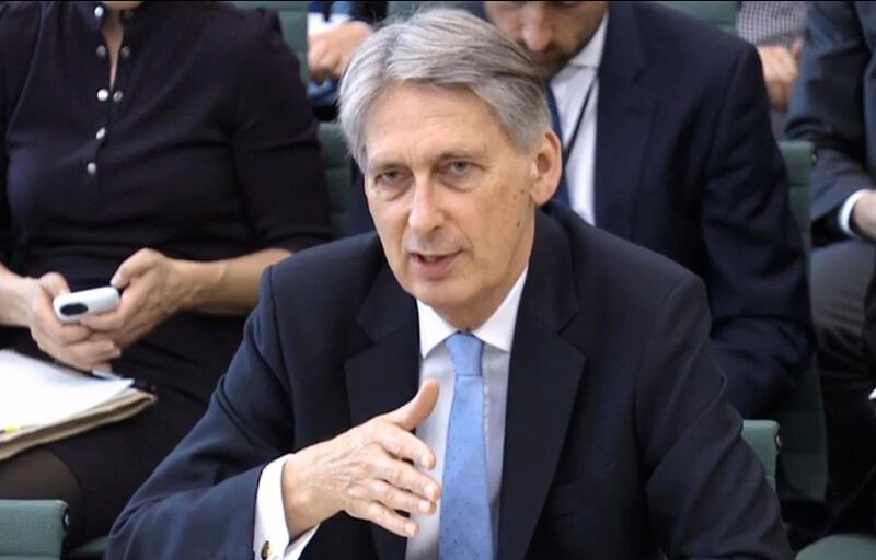 Britain's Chancellor of the Exchequer Philip Hammond answers questions at the parliamentary Commons Treasury Select Committee in  London on Wednesday Oct. 11, 2017.  Hammond said a worst-case Brexit scenario could see all air traffic between the U.K. and the European Union grounded the day after Britain leaves the bloc on March 29, 2019. Philip Hammond was answering lawmakers' questions Wednesday about government planning for the possibility divorce talks could end without a deal on trade, security and other relations.(PA via AP)