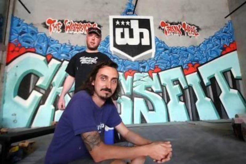 Shaun Sepr, front, and Tom Deams with their Crossfit graffiti at the Warehouse gym in Dubai. Pawan Singh / The National