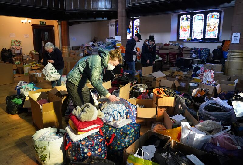 Volunteers from Rain or Shine in Scotland check through donations bound for Ukraine. All photos: PA