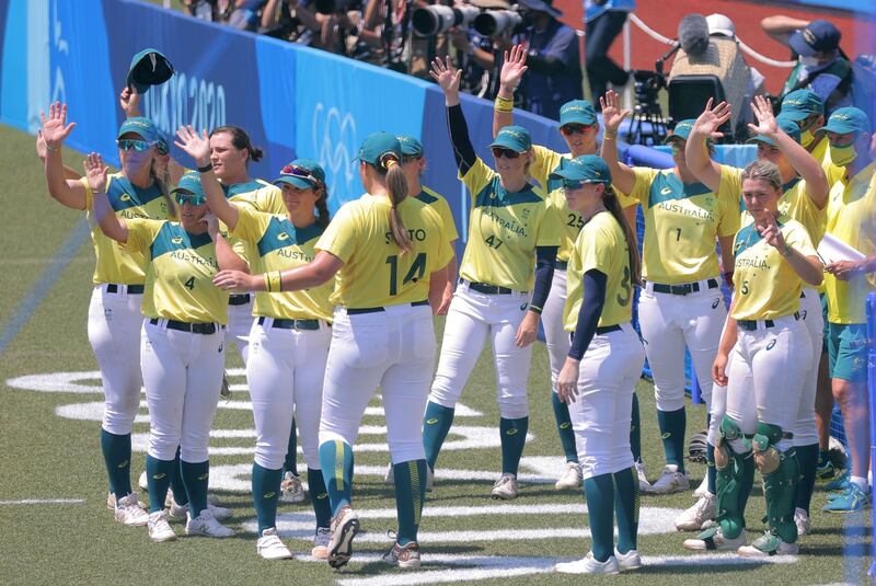 Australia's softball players wave after finishing the Tokyo 2020 Olympic Games softball opening round game.