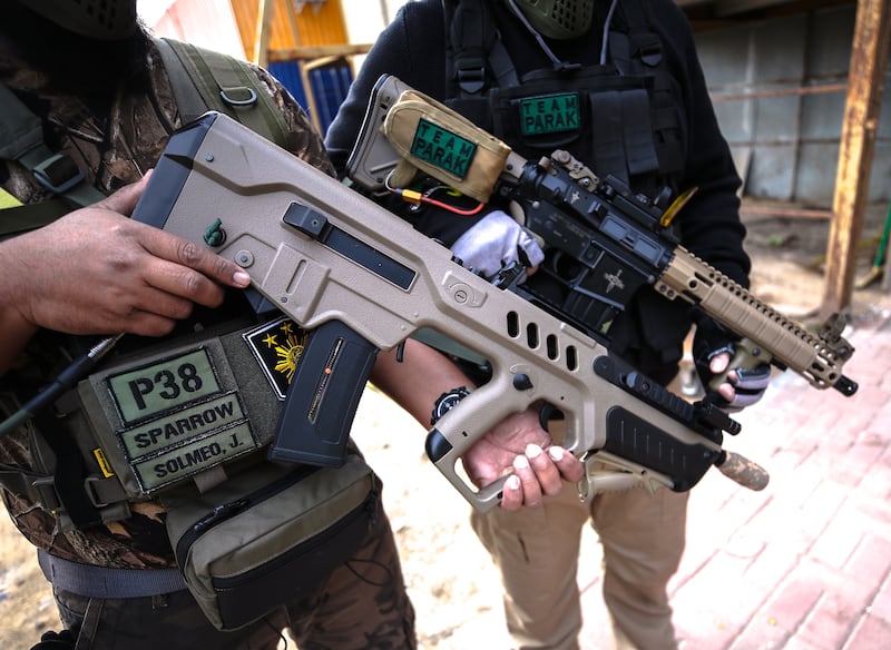 Automatic electric guns, such as the M4-A1, left, and the high pressure Tavor Bullpup, right, work by using pressurised air to fire plastic 'bullets'