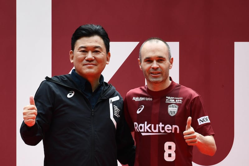 Andres Iniesta and Hiroshi Mikitani, owner of Rakuten and Vissel Kobe club, pose for pictures on the pitch of Noevir Stadium in Kobe, Japan. Martin Bureau / AFP
