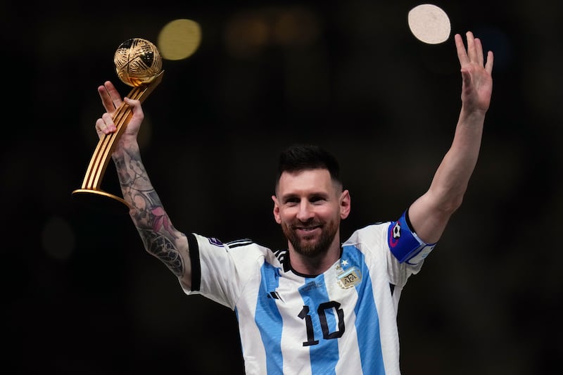 Argentina's Lionel Messi holds up the Golden Ball award for best player of the tournament. AP