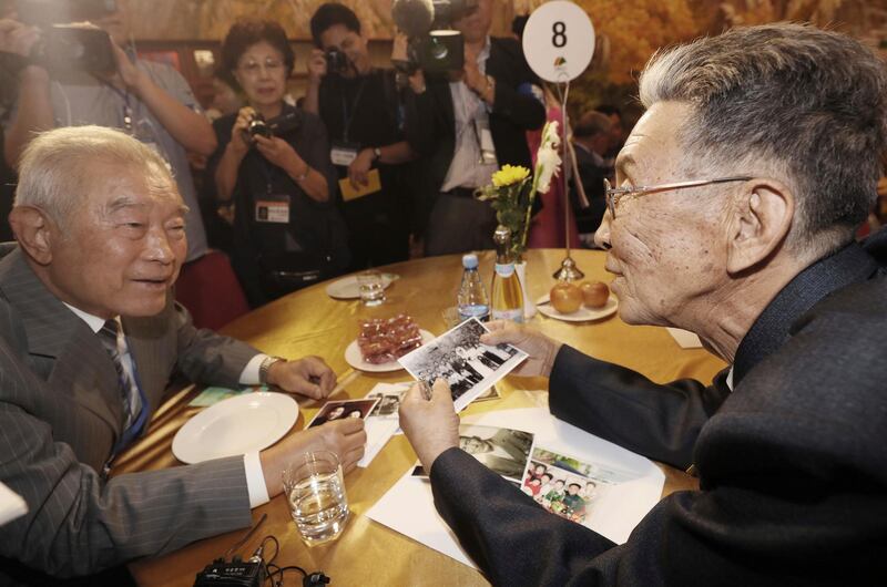 South Korean Kim Kwang-ho, 79, left, talks with his North Korean brother Kim Kwan Il, 78, during the Separated Family Reunion Meeting at the Diamond Mountain resort in North Korea, Monday, Aug. 20, 2018. Dozens of elderly South Koreans crossed the heavily fortified border into North Korea on Monday for heart-wrenching meetings with relatives most haven't seen since they were separated by the turmoil of the Korean War. (Lee Ji-eun/Yonhap via AP)