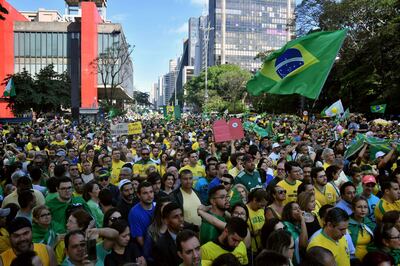 Supporters of Brazilian right-wing presidential candidate Jair Bolsonaro take part in a rally along Paulista Avenue in Sao Paulo Brazil on October 21 2018. Barring any last-minute upset, Brazil appears poised to elect Jair Bolsonaro, a populist far-right veteran politician, as its next president in a week's time. / AFP / NELSON ALMEIDA
