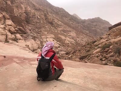 A Bedouin sits on rocks in Wadi Rum. The coronavirus has crushed tourism across Jordan, but the country is waiting patiently for travellers to return. Courtesy Hayley Skirka 