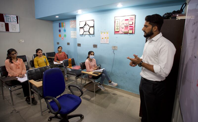 Akhil Katyal, a teacher at Broadway Immigration Services in Jalandhar, in India’s northern state of Punjab, gives an English language class for students who want to move to an English-speaking country.  All photos: Taniya Dutta / The National  