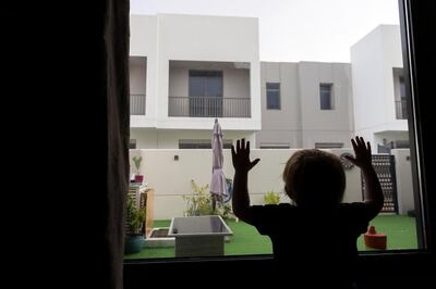 Dubai, United Arab Emirates - Reporter: N/A: Weather. A young boy looks out the window as rain and hail comes down in Dubai. Sunday, May 24th, 2020. Dubai. Chris Whiteoak / The National