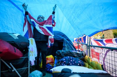 Royalist John Loughrey shows off the inside of 'Hotel Buck' as he begins his fifth day camping on the route of the Coronation near Buckingham Palace. Getty 