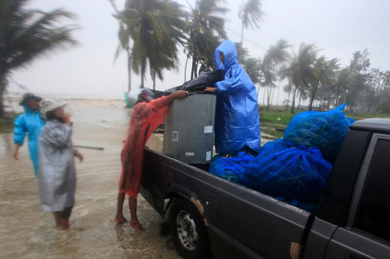 Locals clear out supplies from the coastline in preparation for the approaching Tropical Storm Pabuk, in Pak Phanang, in the southern province of Nakhon Si Thammarat, southern Thailand. AP Photo