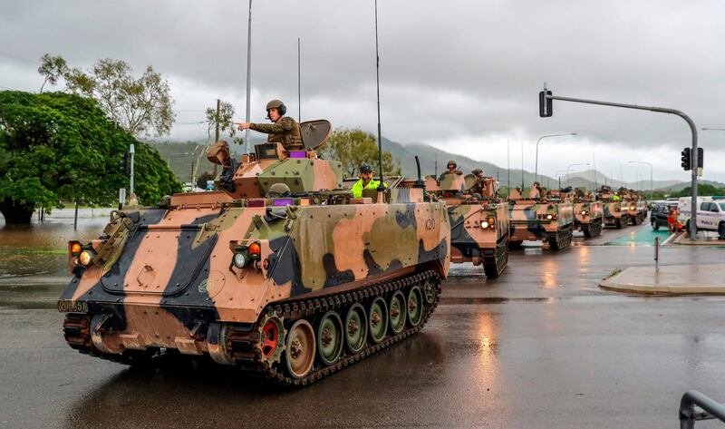 Army vehicles enter Townsville to help evacuate residents. AFP