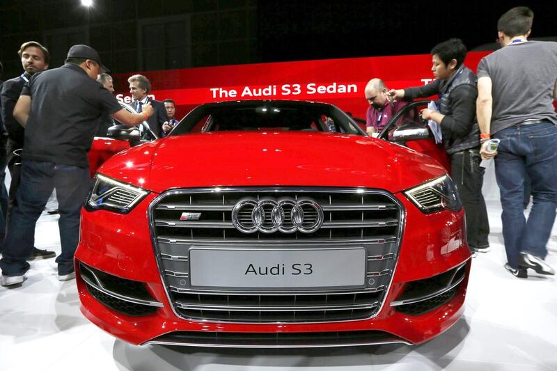 Auto show attendees look over the Audi S3 during the 2013 Los Angeles Auto Show. REUTERS/Lucy Nicholson