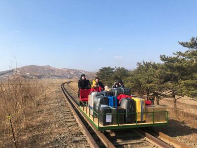 Russian diplomats and family members leave North Korea to Russia using a hand-pushed rail trolley due to Pyongyang's coronavirus restrictions on February 25, 2021. RESTRICTED TO EDITORIAL USE - MANDATORY CREDIT "AFP PHOTO / Russian Foreign Ministry / handout" - NO MARKETING NO ADVERTISING CAMPAIGNS - DISTRIBUTED AS A SERVICE TO CLIENTS --- NO ARCHIVE ---

 / AFP / RUSSIAN FOREIGN MINISTRY / Handout / RESTRICTED TO EDITORIAL USE - MANDATORY CREDIT "AFP PHOTO / Russian Foreign Ministry / handout" - NO MARKETING NO ADVERTISING CAMPAIGNS - DISTRIBUTED AS A SERVICE TO CLIENTS --- NO ARCHIVE ---

