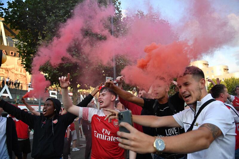 Arsenal fans celebrate outside the Emirates stadium. AFP