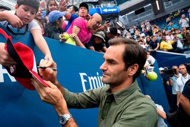 Roger Federer signs autographs as he prepares for his tilt at winning the US Open for a sixth time. AFP