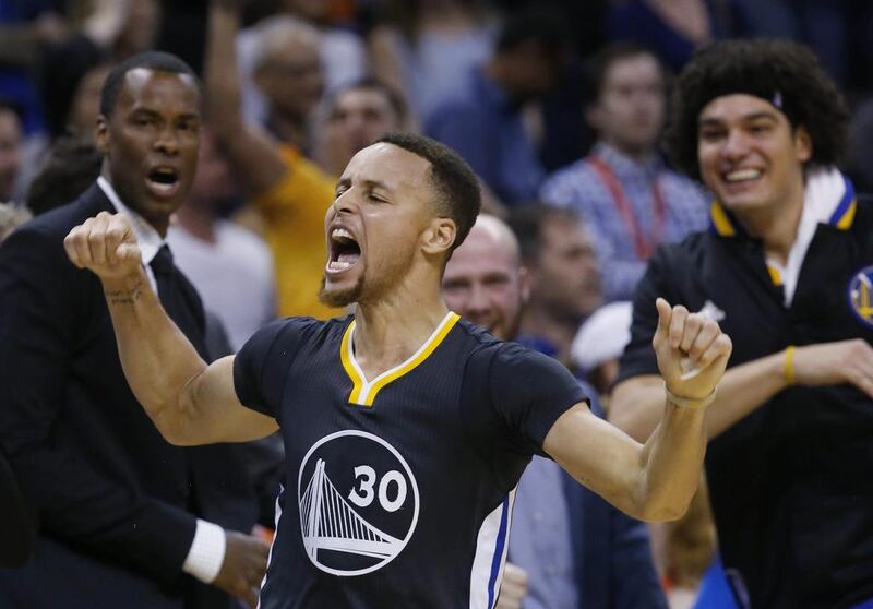 Golden State Warriors guard Stephen Curry (30) celebrates after hitting the game-winning shot in overtime of an NBA basketball game against the Oklahoma City Thunder in Oklahoma City, Saturday, Feb. 27, 2016. Golden State won 121-118. (AP Photo/Sue Ogrocki)