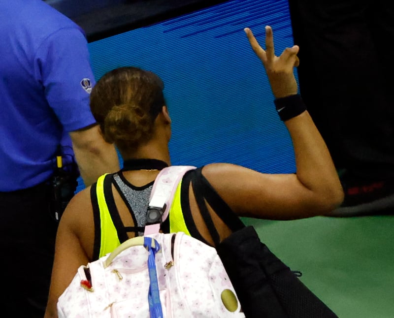 Naomi Osaka of Japan gives the peace sign to the crowd as she walks off the court after losing.  EPA
