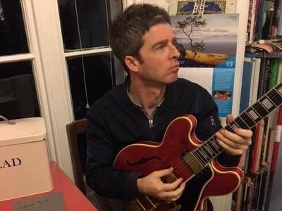Noel Gallagher with the restored guitar. Photo: Philippe Dubreuille