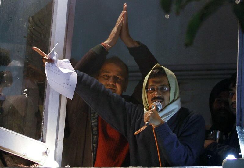 Delhi's Chief Minister Arvind Kejriwal waves his resignation letter in front of supporters at Aam Aadmi (Common Man) Party offices. A readers suggests his stand in a principled one that will in time be rewarded electorally. AFP 