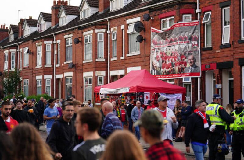 Fans walk to the ground ahead of an organised protest against the Manchester United owners. Getty