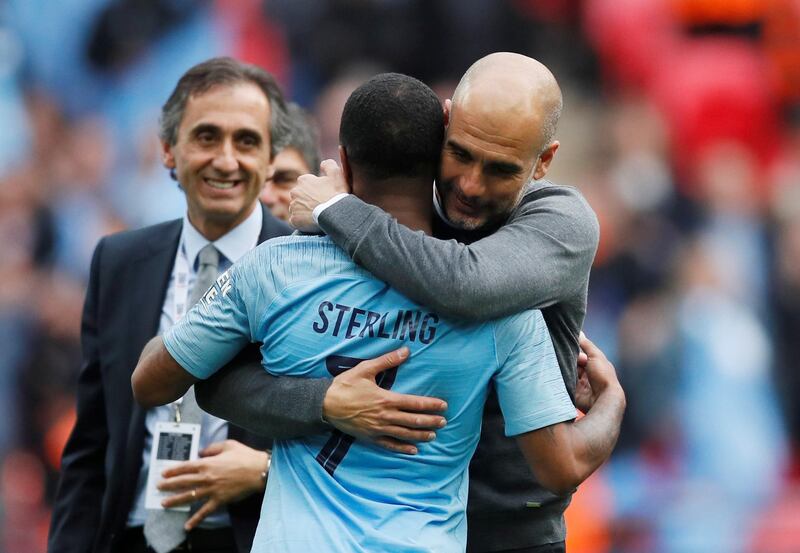 Manchester City manager Pep Guardiola hugs Raheem Sterling. Reuters