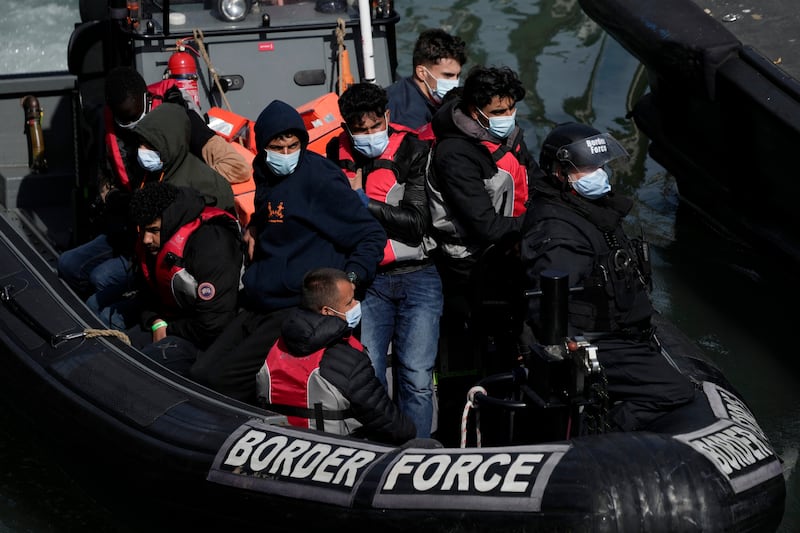 Migrants who tried to cross from France in small boats arrive in Dover, south-east England. AP