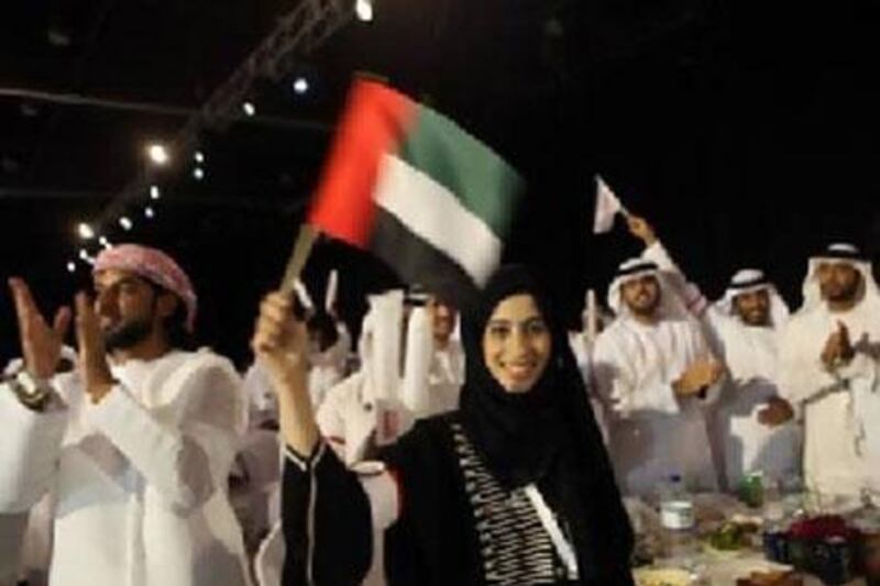 Volunteers celebrate in Abu Dhabi yesterday during a ceremony honouring Emirati Foundation's community service workers.  ?