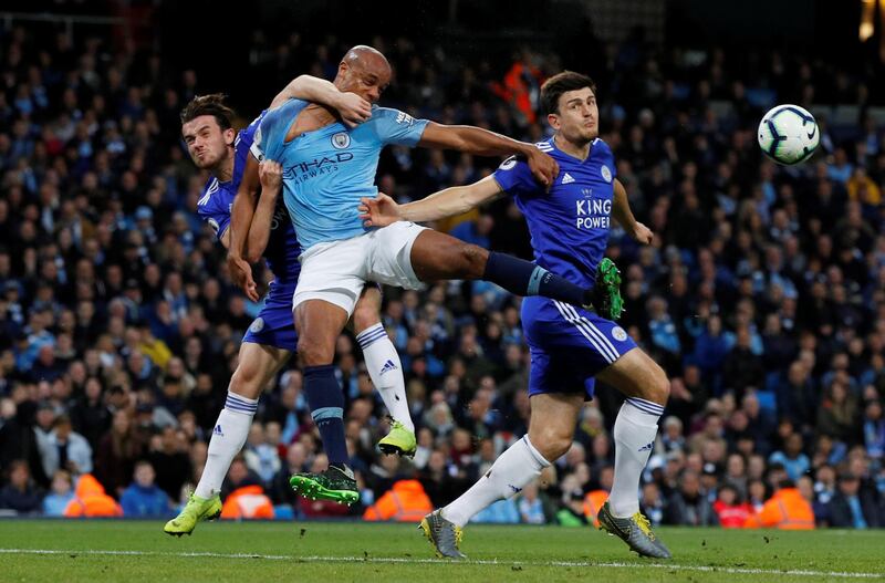Vincent Kompany in action against Ben Chilwell and Harry Maguire. Reuters
