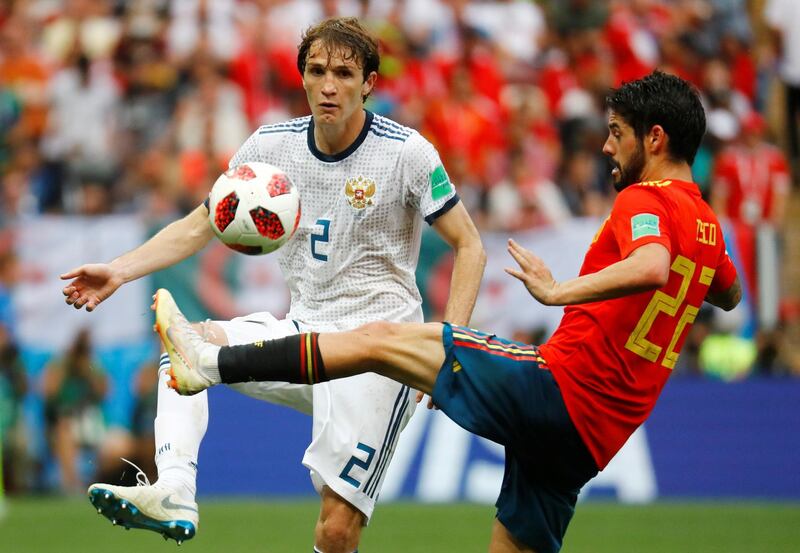 Soccer Football - World Cup - Round of 16 - Spain vs Russia - Luzhniki Stadium, Moscow, Russia - July 1, 2018  Russia's Mario Fernandes in action with Spain's Isco                       REUTERS/Kai Pfaffenbach