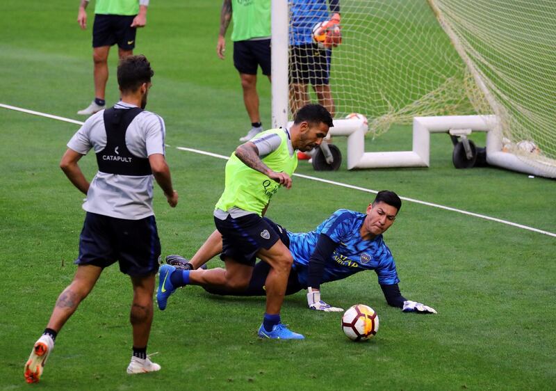 Boca Juniors player Carlos Tevez takes on goalkeeper Esteban Andrada during a training session. Reuters