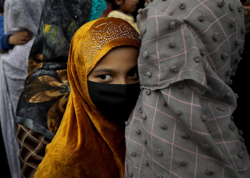A young protester at a demonstration against hijab restrictions in Kolkata, east India. People have marched in solidarity with six students banned from a college in southern Karnataka state for wearing headscarves in class. EPA