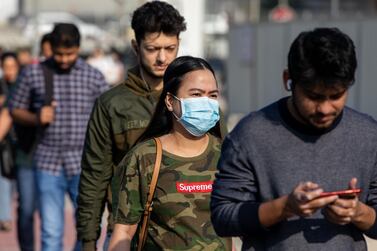A commuter wears a face mask while exiting a metro station in Dubai. The UAE recorded it's 86th case of Covid-19 on Sunday morning. Bloomberg