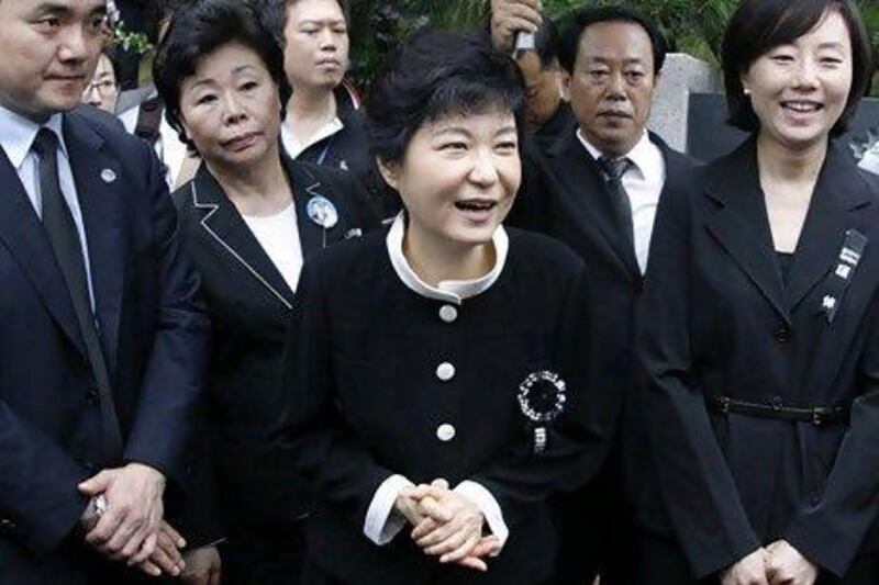 Park Geun-hye, centre, greets people after a memorial service for her mother and the late first lady Yuk Young-soo at the national cemetery in Seoul on August 15, 2012. Lee Jae-Won / Reuters