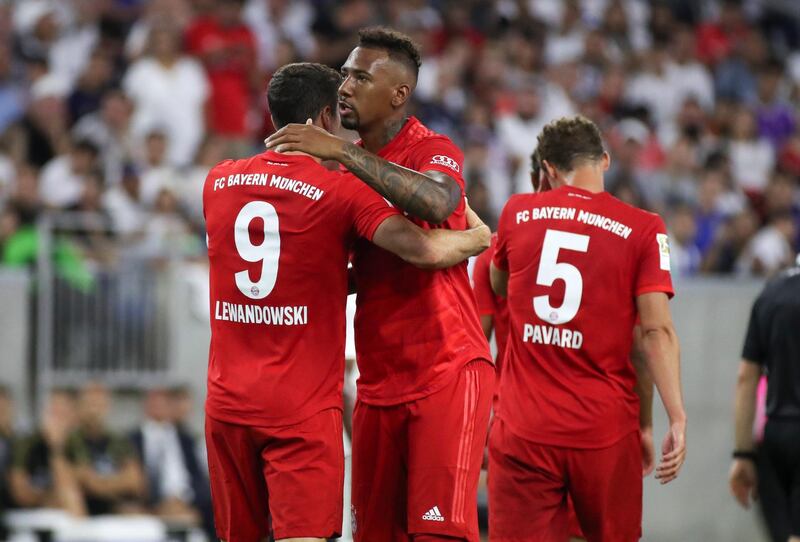 Bayern's Robert Lewandowski, back to camera on left, celebrates with defender Jerome Boateng after scoring. Reuters