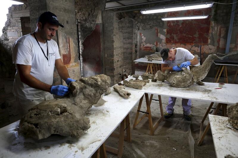 Restorers work to piece together fragments of bodies that have come away from plaster cast moulds of the victims of the Mount Vesuvius eruption in AD79. Alessandro Bianchi / Reuters